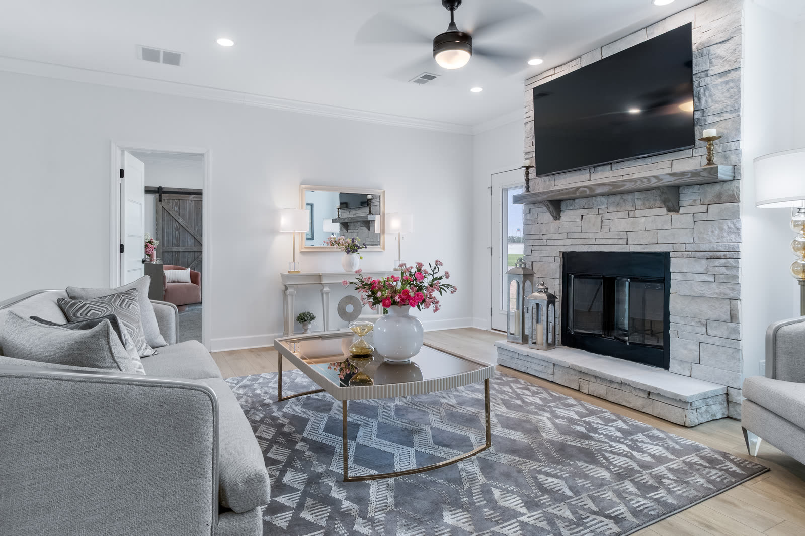 Living room with a stacked stone fireplace